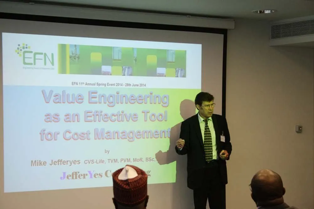 A presenter speaks in front of the projected slide “Value Engineering as an Effective Tool for Cost Management”.