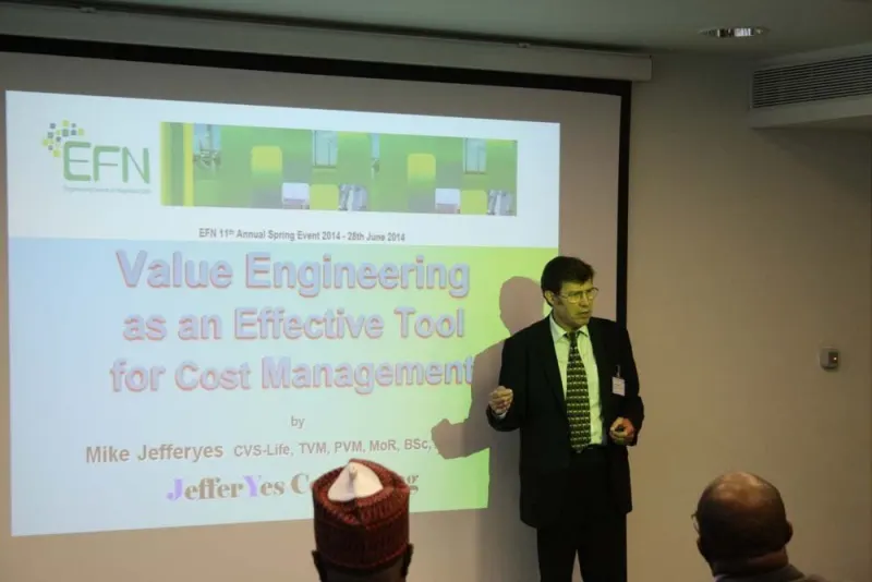 A presenter speaks in front of the projected slide “Value Engineering as an Effective Tool for Cost Management”.